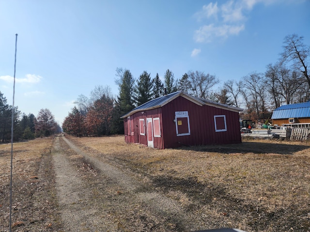 view of side of property featuring an outbuilding