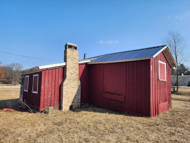 view of outbuilding featuring a yard