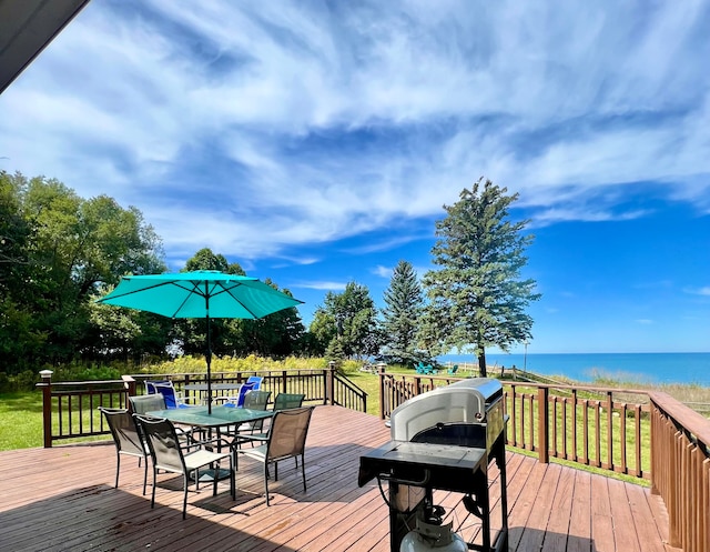 deck with a water view and a beach view