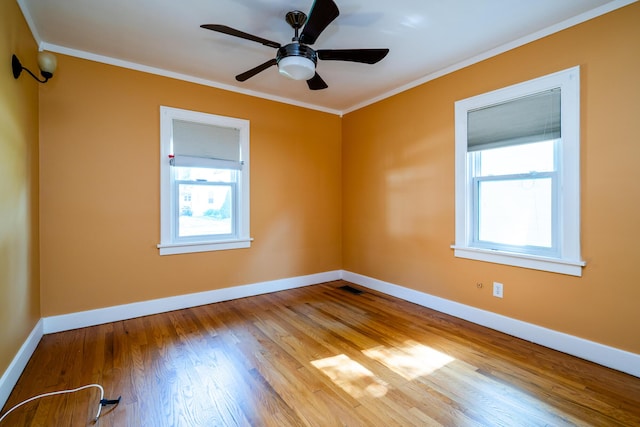 unfurnished room with a healthy amount of sunlight, light wood-type flooring, and ornamental molding