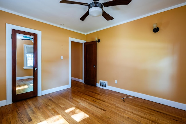 unfurnished bedroom featuring wood-type flooring, ceiling fan, and ornamental molding