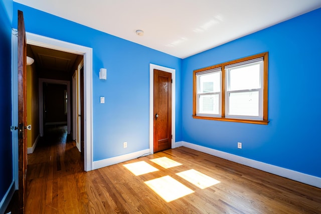 unfurnished bedroom with hardwood / wood-style floors