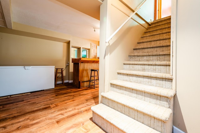 staircase featuring hardwood / wood-style flooring