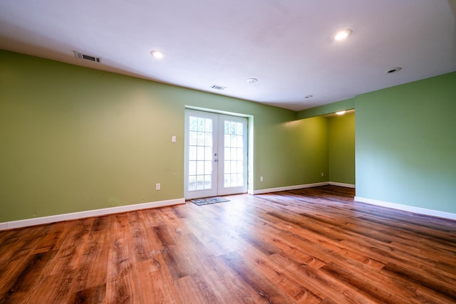 unfurnished room featuring hardwood / wood-style flooring and french doors