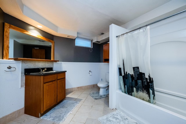 full bathroom featuring vanity, shower / bath combo, and toilet