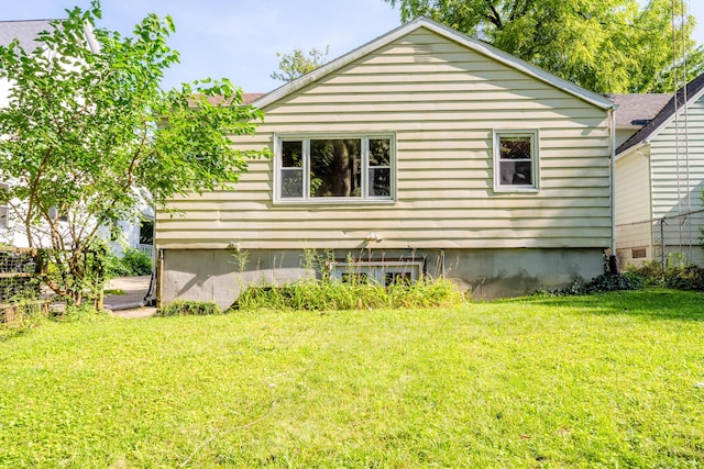 view of side of home featuring a yard