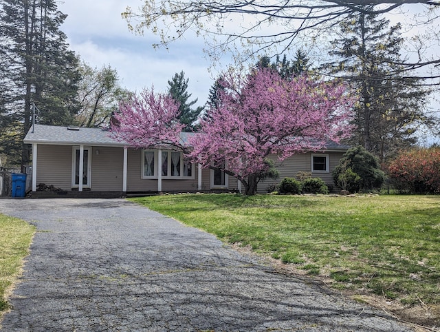 view of front of property with a porch and a front lawn