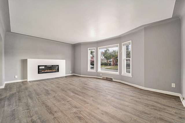 unfurnished living room featuring hardwood / wood-style floors