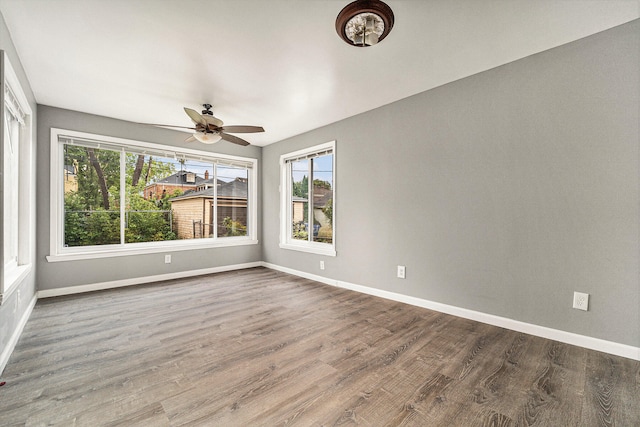 empty room featuring ceiling fan and hardwood / wood-style flooring