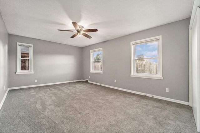 empty room featuring carpet flooring, ceiling fan, and a textured ceiling