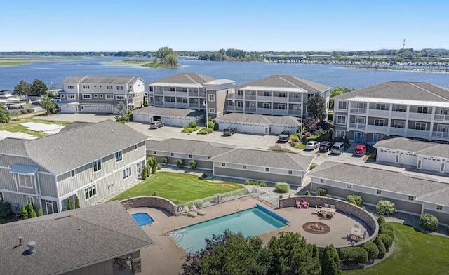 birds eye view of property with a water view