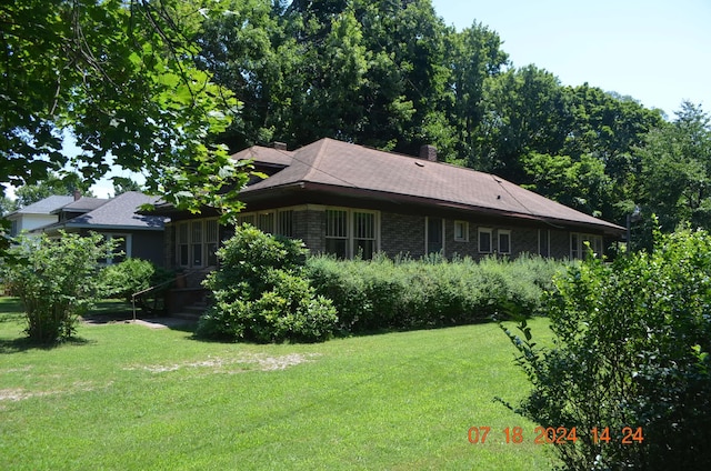 view of side of property with a yard