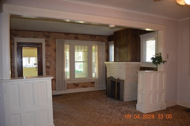 unfurnished living room with crown molding and a fireplace