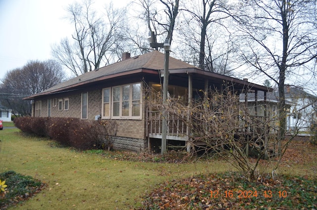 view of home's exterior with a lawn