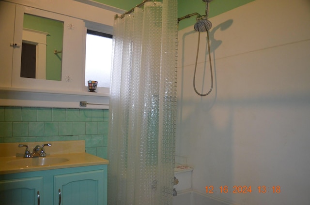 bathroom with tile walls, vanity, and shower / bath combination with curtain