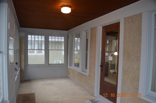 unfurnished sunroom featuring wooden ceiling