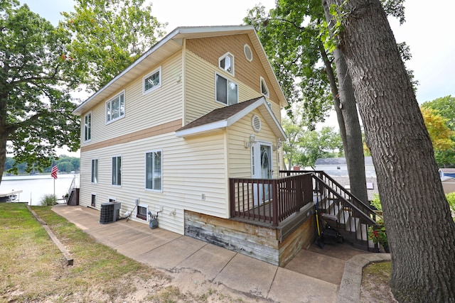 rear view of property featuring central AC and a patio