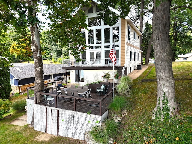 rear view of house featuring a deck