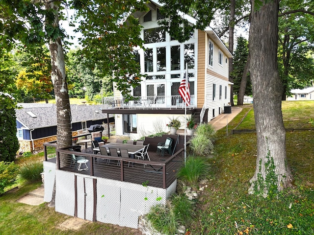 back of house featuring a wooden deck