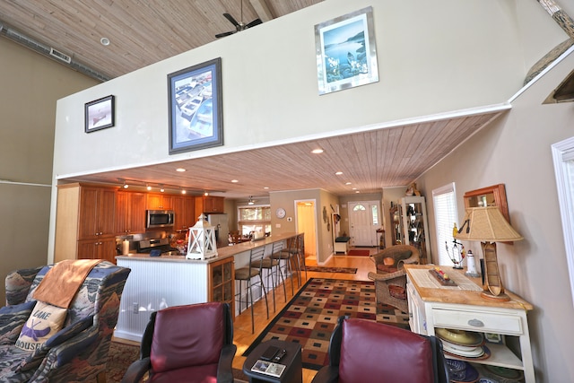 living room featuring hardwood / wood-style floors and wood ceiling