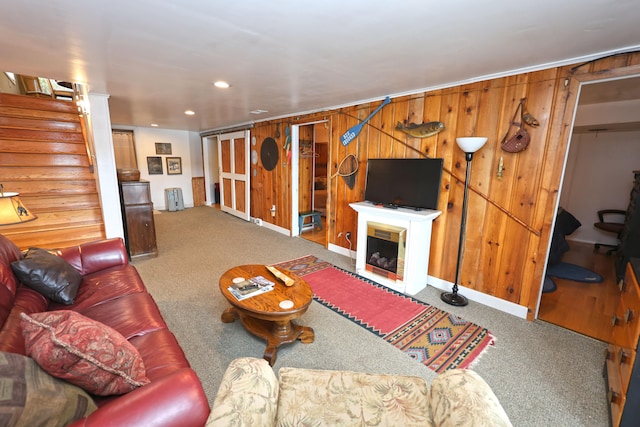 living room featuring wooden walls and carpet flooring