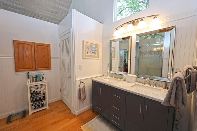 bathroom featuring hardwood / wood-style floors, an enclosed shower, vanity, wood walls, and wooden ceiling