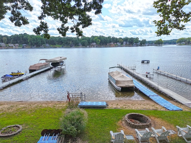 view of dock featuring an outdoor fire pit and a water view