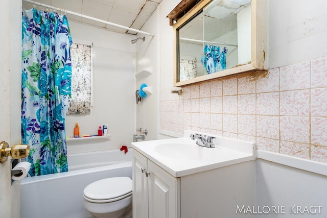 full bathroom featuring toilet, tasteful backsplash, vanity, tile walls, and shower / tub combo