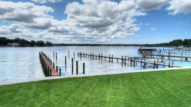 dock area with a water view and a lawn