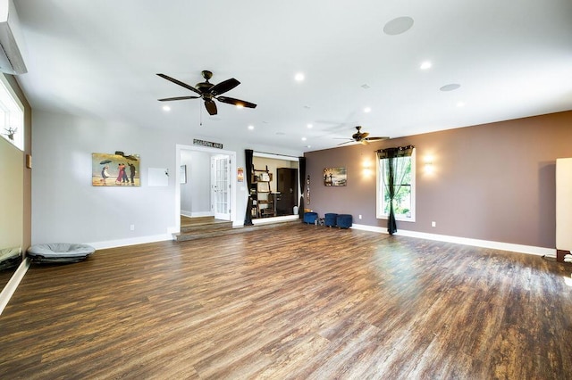 unfurnished living room with dark wood-type flooring and ceiling fan