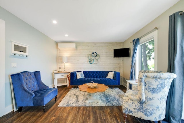 living room with a wall mounted air conditioner, wooden walls, and dark hardwood / wood-style floors