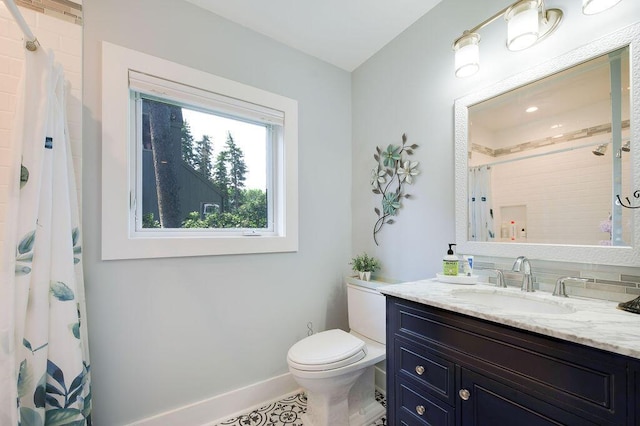 bathroom featuring vanity, toilet, and a shower with shower curtain