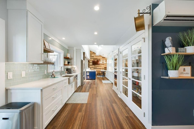 kitchen featuring french doors, sink, tasteful backsplash, dark hardwood / wood-style flooring, and white cabinets