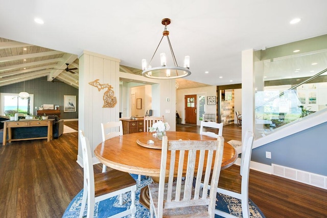 dining room featuring ceiling fan with notable chandelier, lofted ceiling with beams, and dark hardwood / wood-style floors