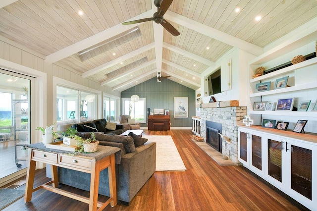 living room featuring vaulted ceiling with beams, dark wood-type flooring, a fireplace, and wood ceiling