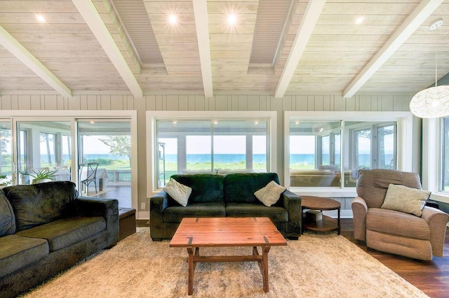 sunroom / solarium featuring beamed ceiling