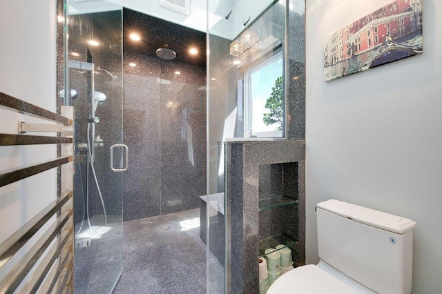 bathroom with toilet and walk in shower