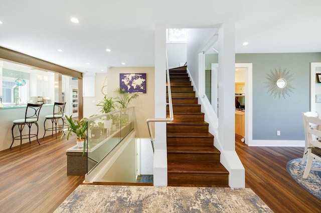 stairs featuring wood-type flooring