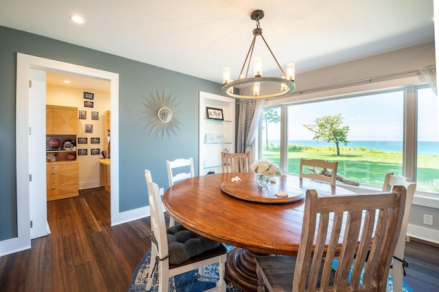 dining area with dark hardwood / wood-style floors and a notable chandelier