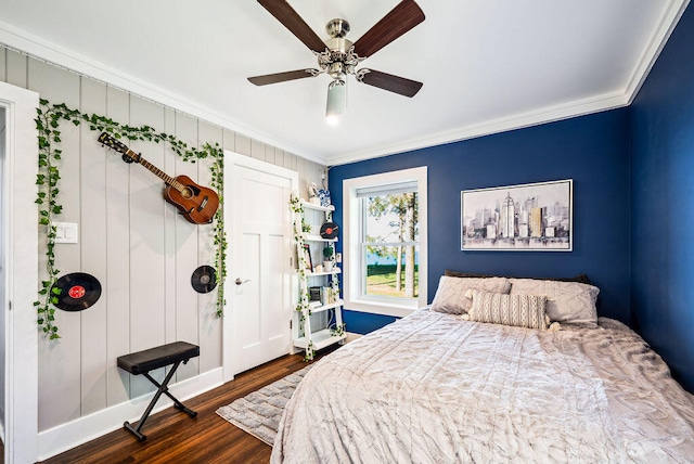 bedroom featuring ceiling fan, ornamental molding, and dark hardwood / wood-style floors