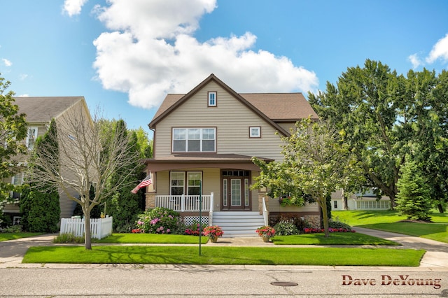 craftsman inspired home with a front lawn and covered porch