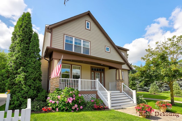 view of front of house with covered porch and a front yard