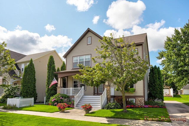 view of front of home with a porch and a front lawn