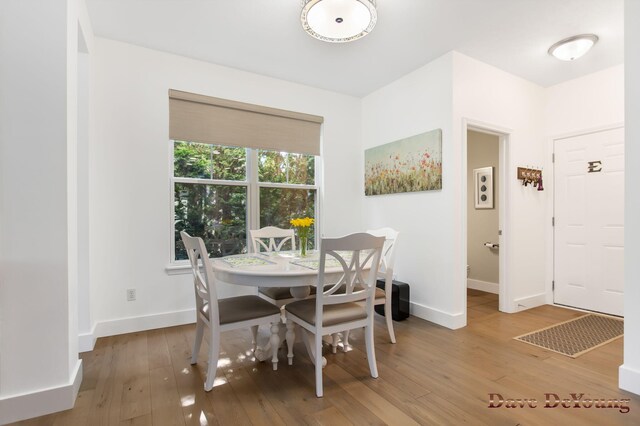 dining space with light hardwood / wood-style flooring