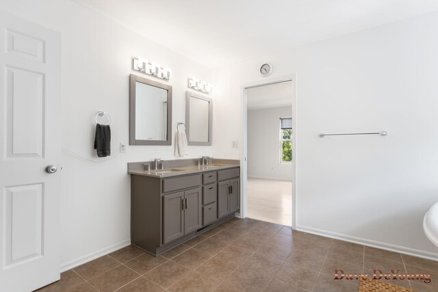 bathroom with dual vanity and tile patterned flooring