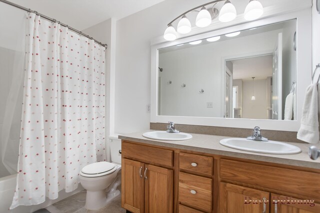 full bathroom with toilet, tile patterned flooring, shower / tub combo, and double vanity