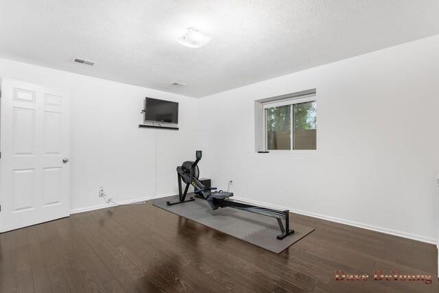 workout area with a textured ceiling and hardwood / wood-style flooring