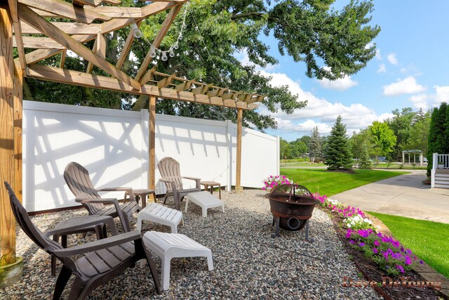 view of patio / terrace with a pergola and an outdoor fire pit