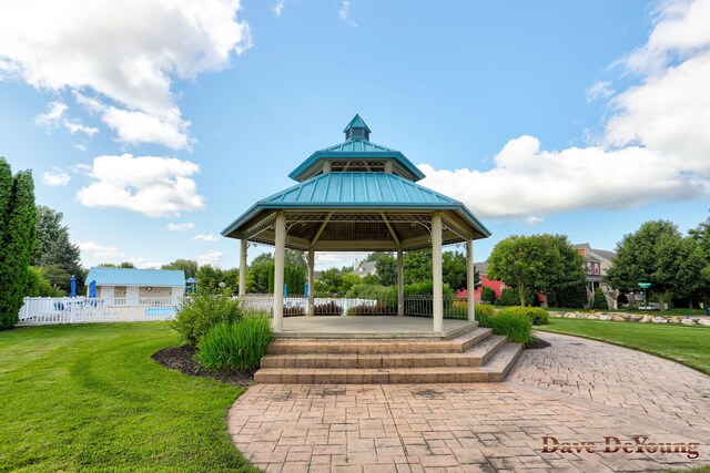 view of property's community with a yard and a gazebo