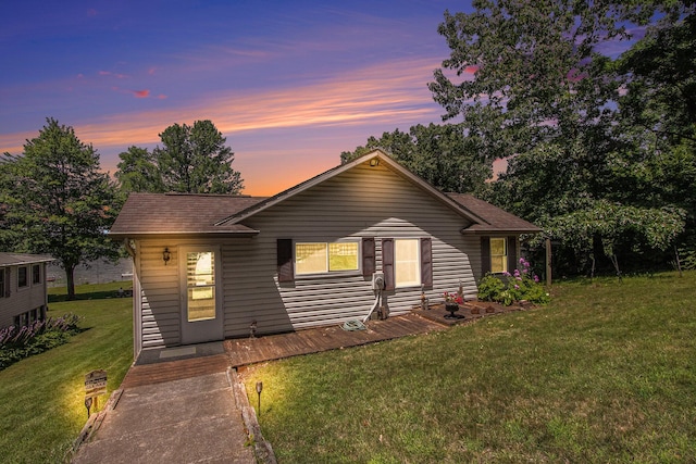 single story home featuring a lawn